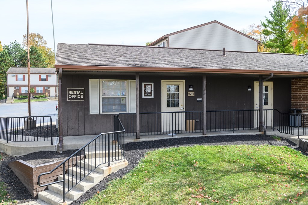 the front of a building with stairs and a ramp