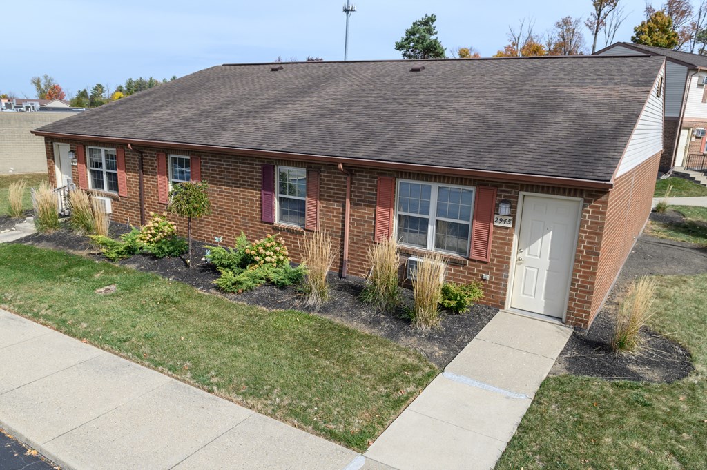 the front of a brick house with a white door