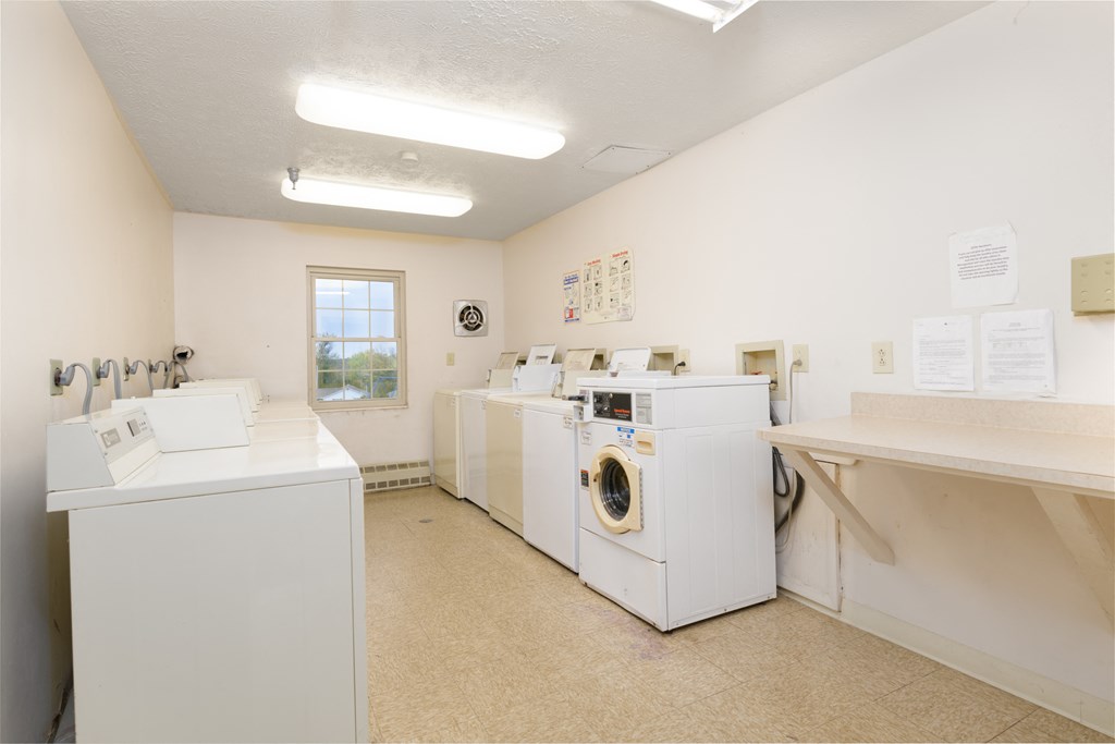 a washer and dryer room with washing machines and dryers in a room