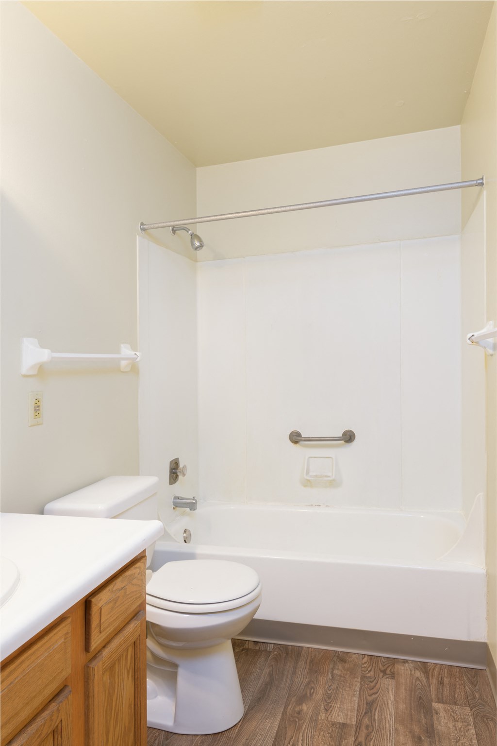 a bathroom with a toilet and a tub and a sink