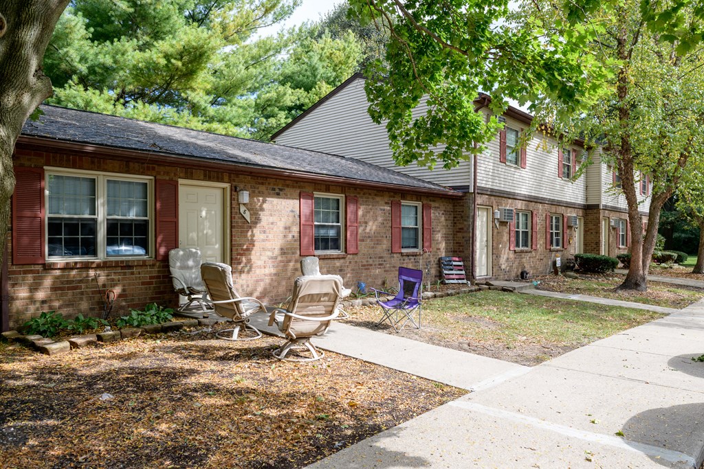a brick house with two rocking chairs in front of it