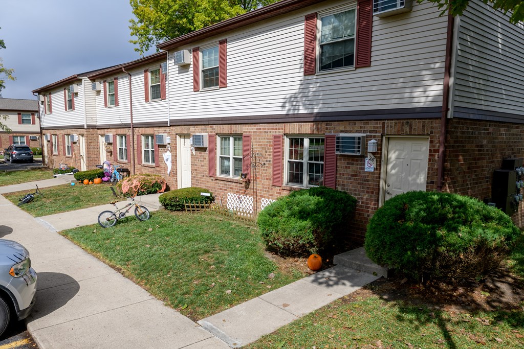 the front of a house with a bicycle parked in the front yard