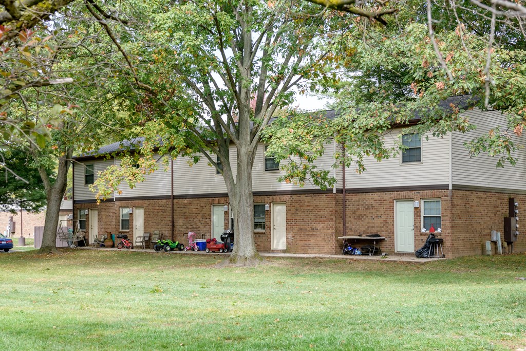 our apartments are located in a large brick building with trees