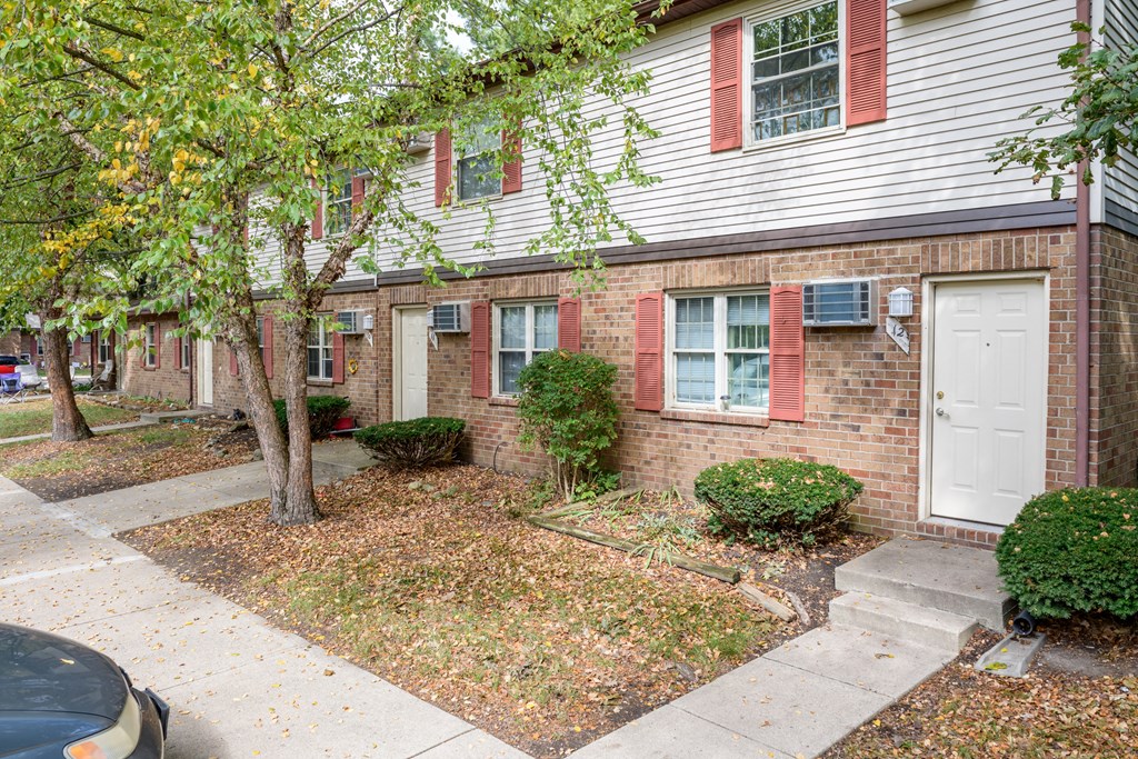 the front of a brick house with a white door