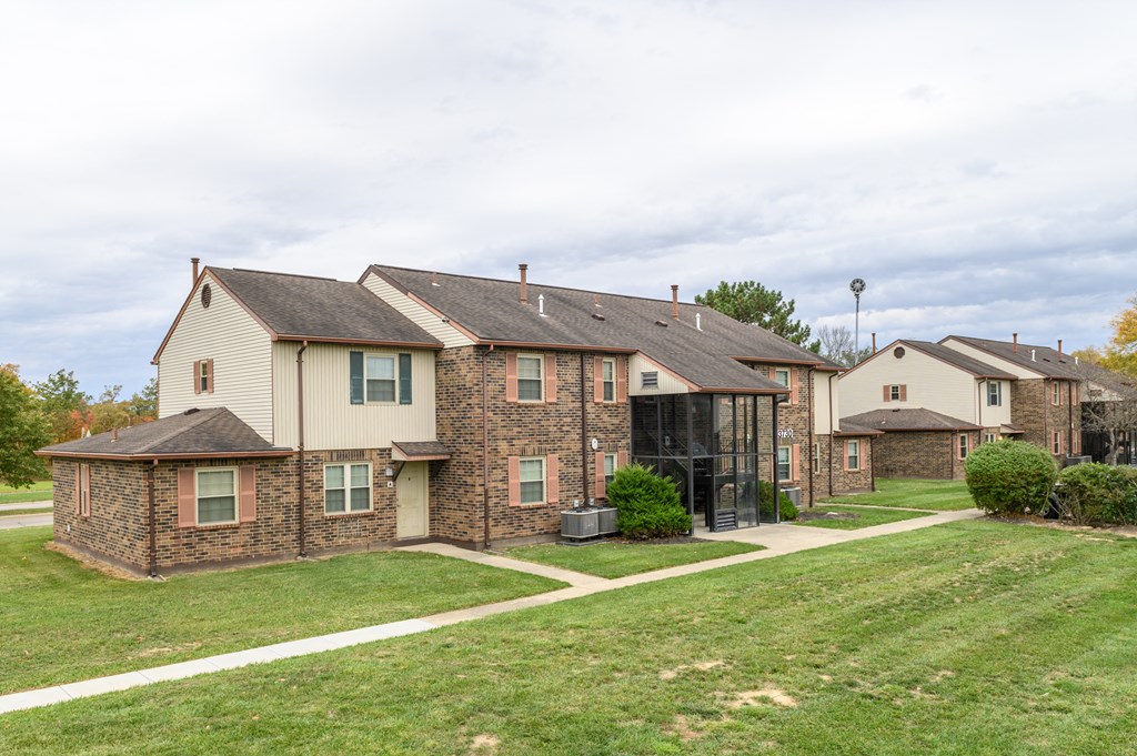a group of houses on the side of a field