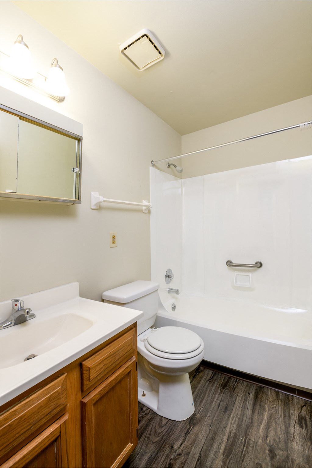 a bathroom with a toilet and a sink and a shower