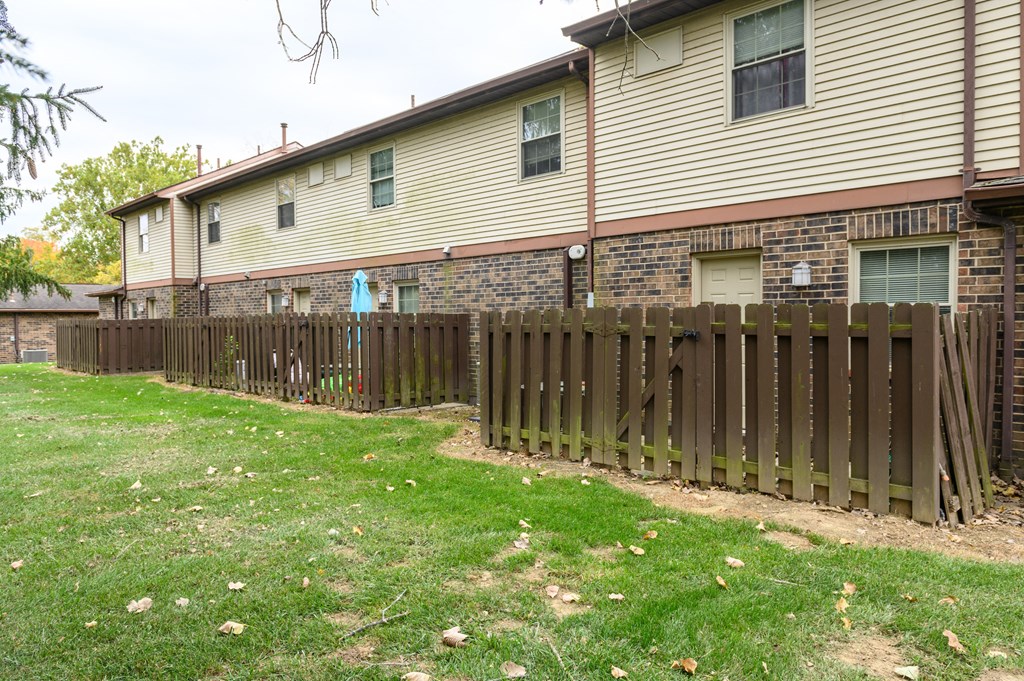 a house with a wooden fence in front of it
