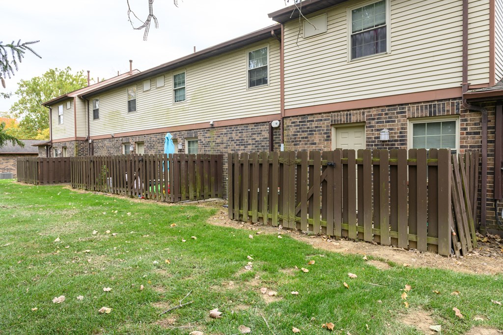 a wooden fence in front of a house