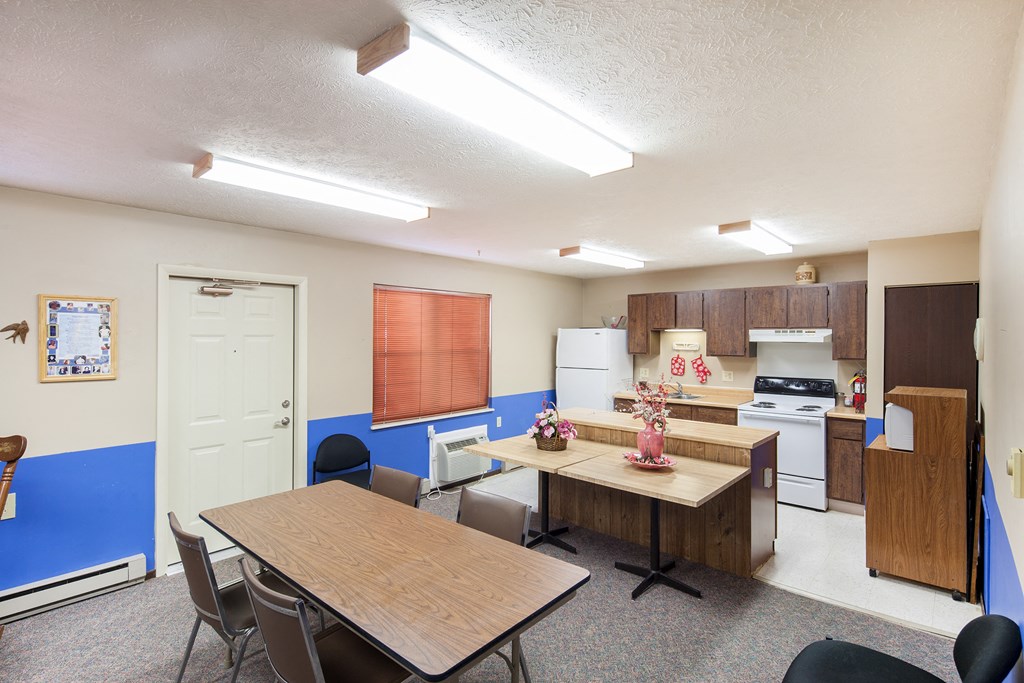 a dining room and kitchen with a table and chairs
