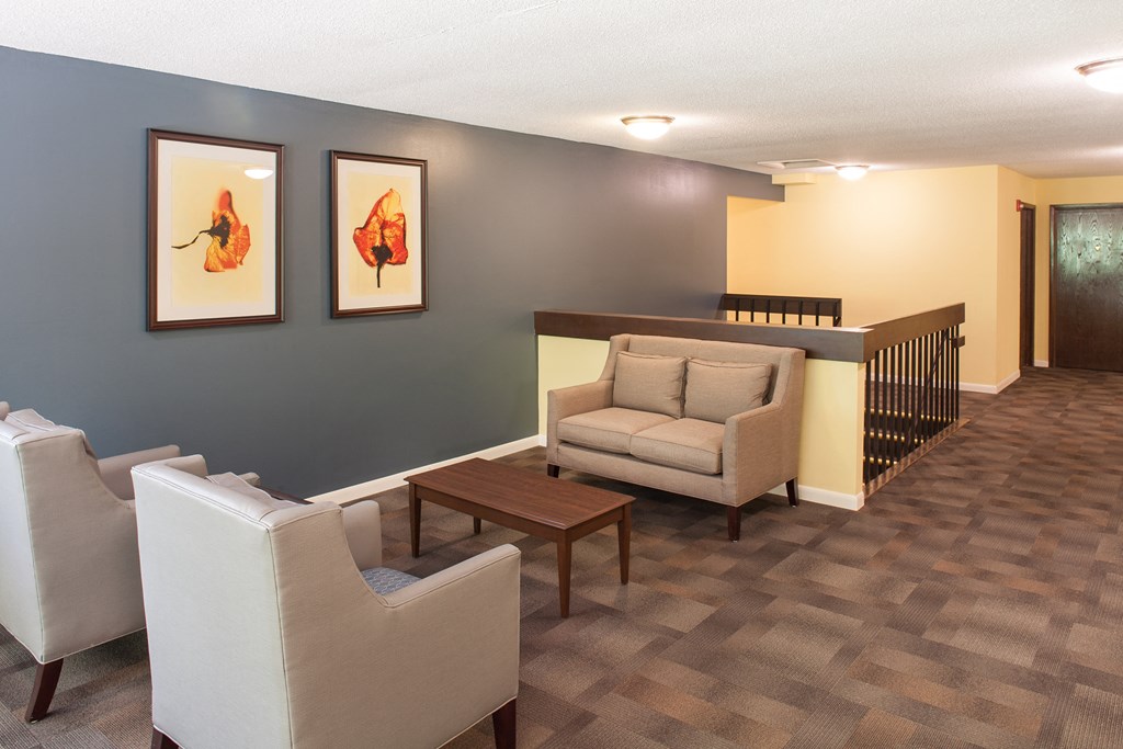a living room with couches and chairs and a table