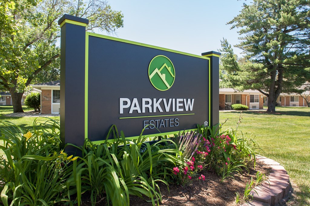 a parkview estates sign in front of a lawn and trees