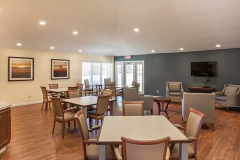 a dining room with tables and chairs and a television