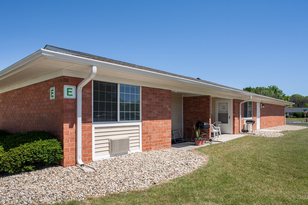 the front of a brick building with a sign on the side of it