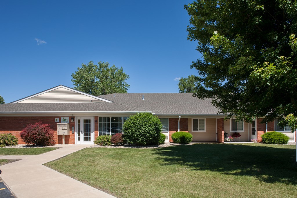 an office building with a lawn in front of it