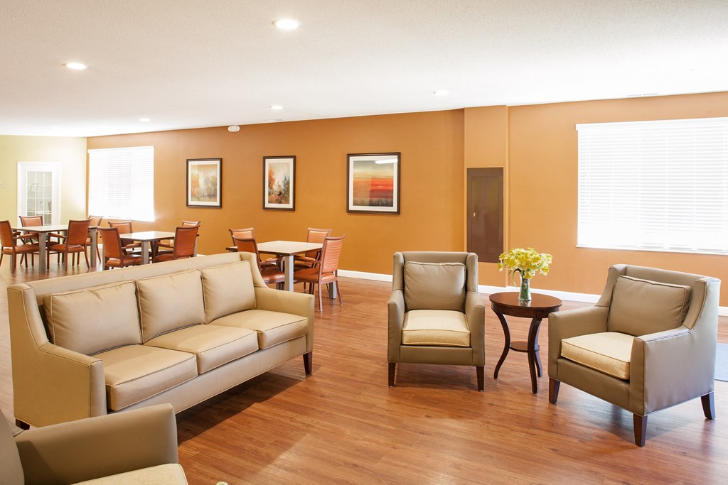 a living room with couches chairs and tables