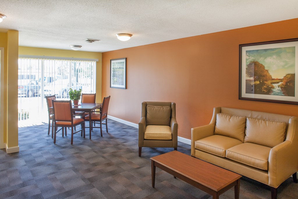 a living room and dining room with couches and a table