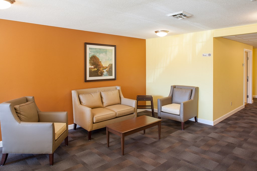 a living room with couches and chairs and a table