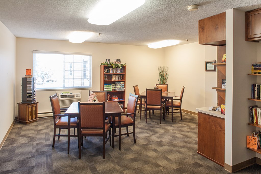 a dining room with a table and chairs and a window
