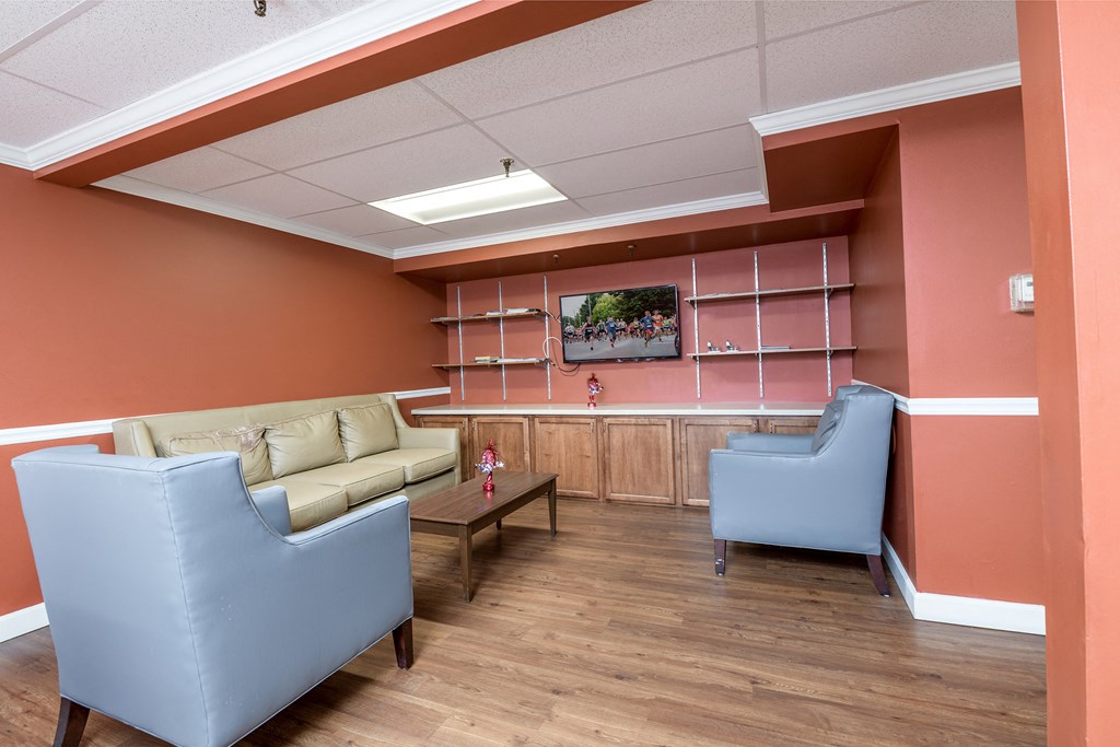 a waiting room in a hospital with couches and a table