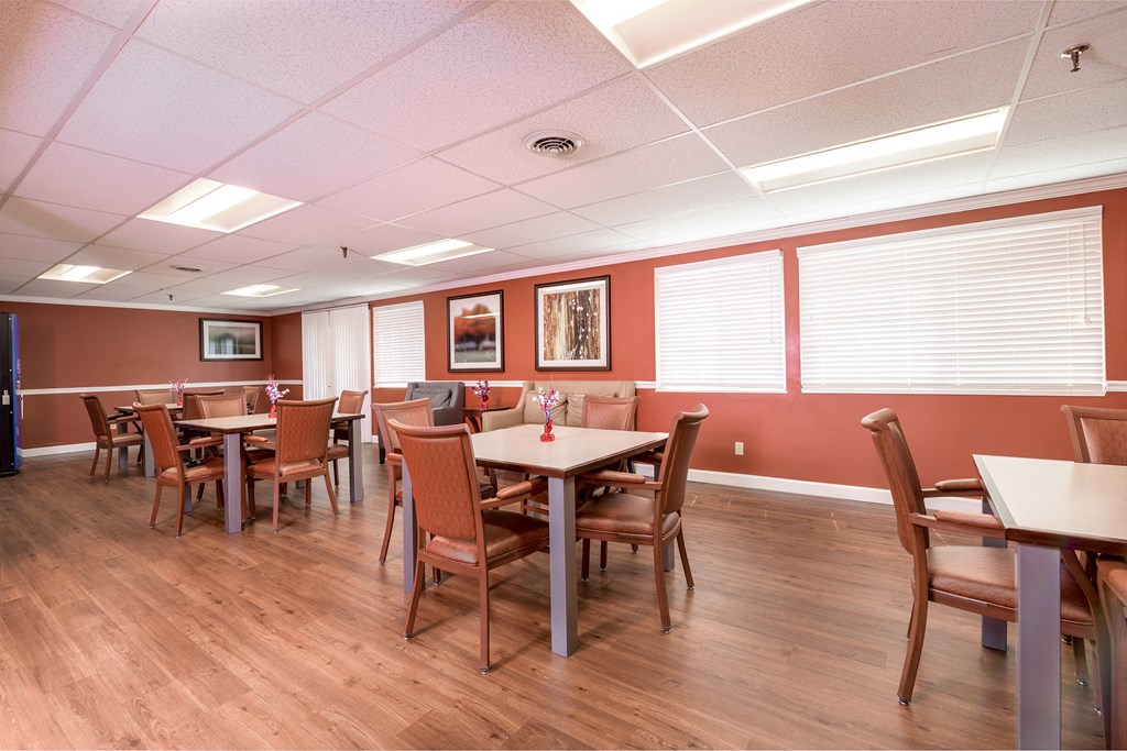 a dining room with tables and chairs and a wood floor