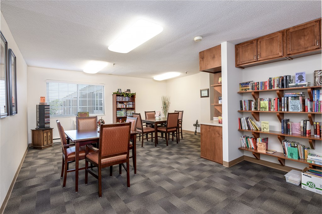 a dining room with a table and chairs and a library