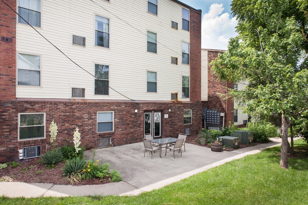 our apartments offer a patio with a table and chairs