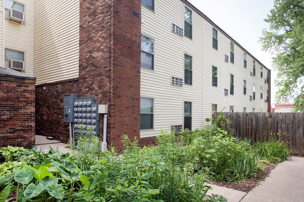 a garden in front of an apartment building