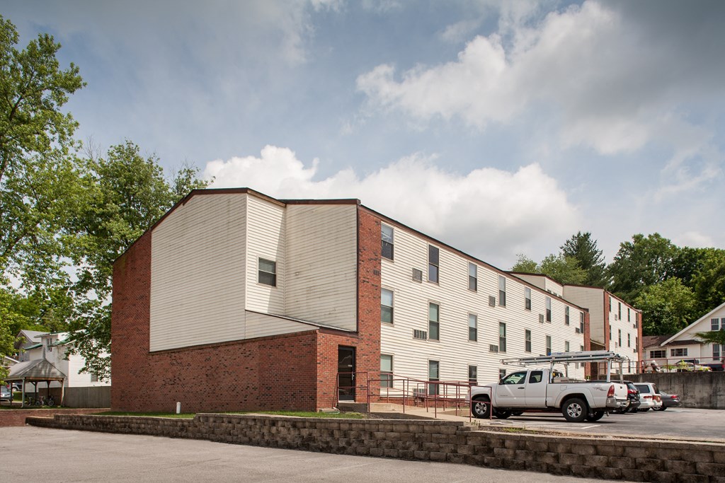 an apartment building with a truck parked in front of it