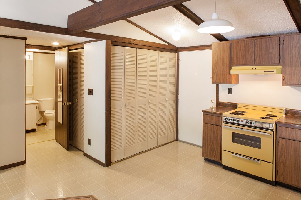 a kitchen with a stove and a refrigerator