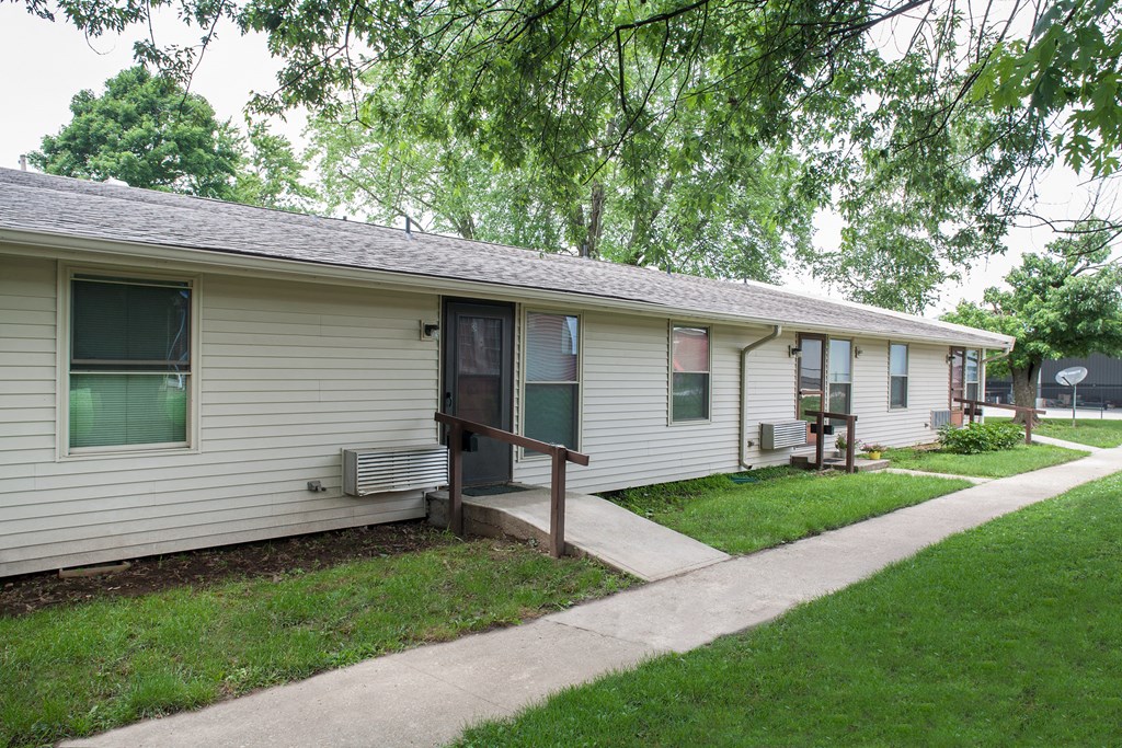 a white house with a porch and a sidewalk