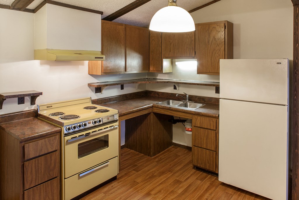 a kitchen with a yellow stove and a refrigerator