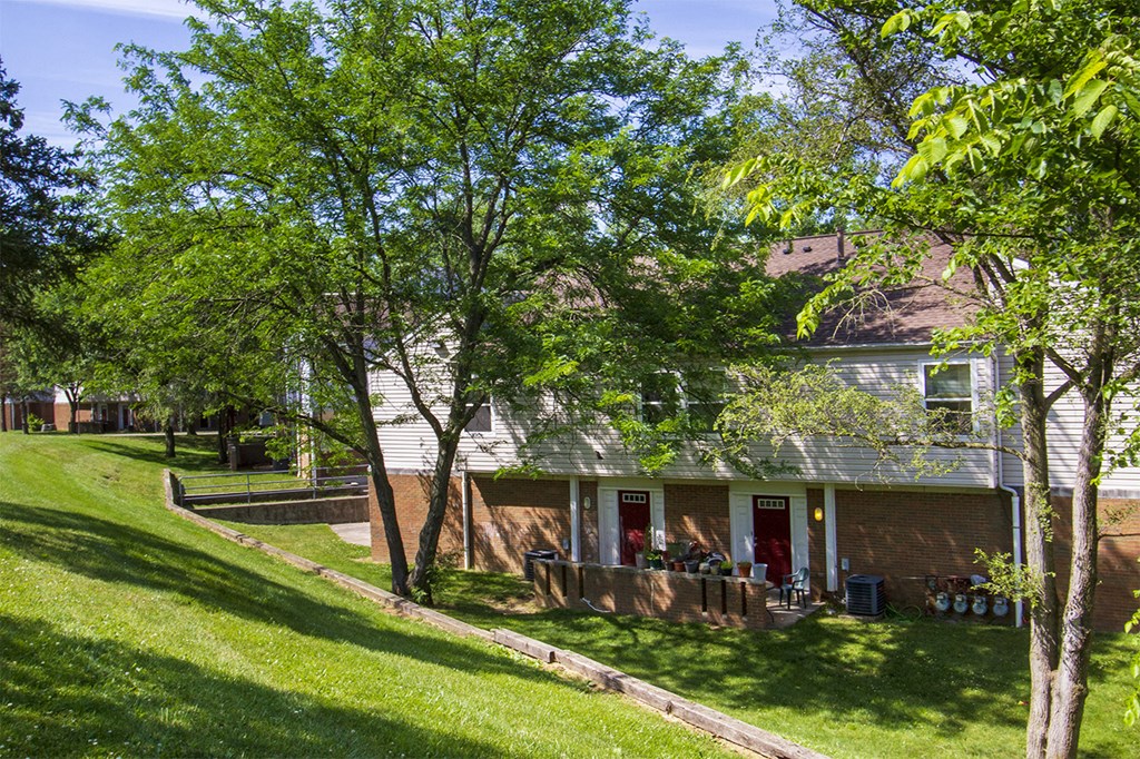 the front of a house with a yard and trees