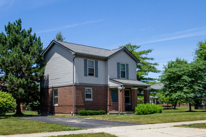 a brick and with a gray roof and a sidewalk