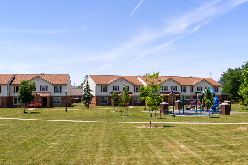 an image of a yard with houses and a playground