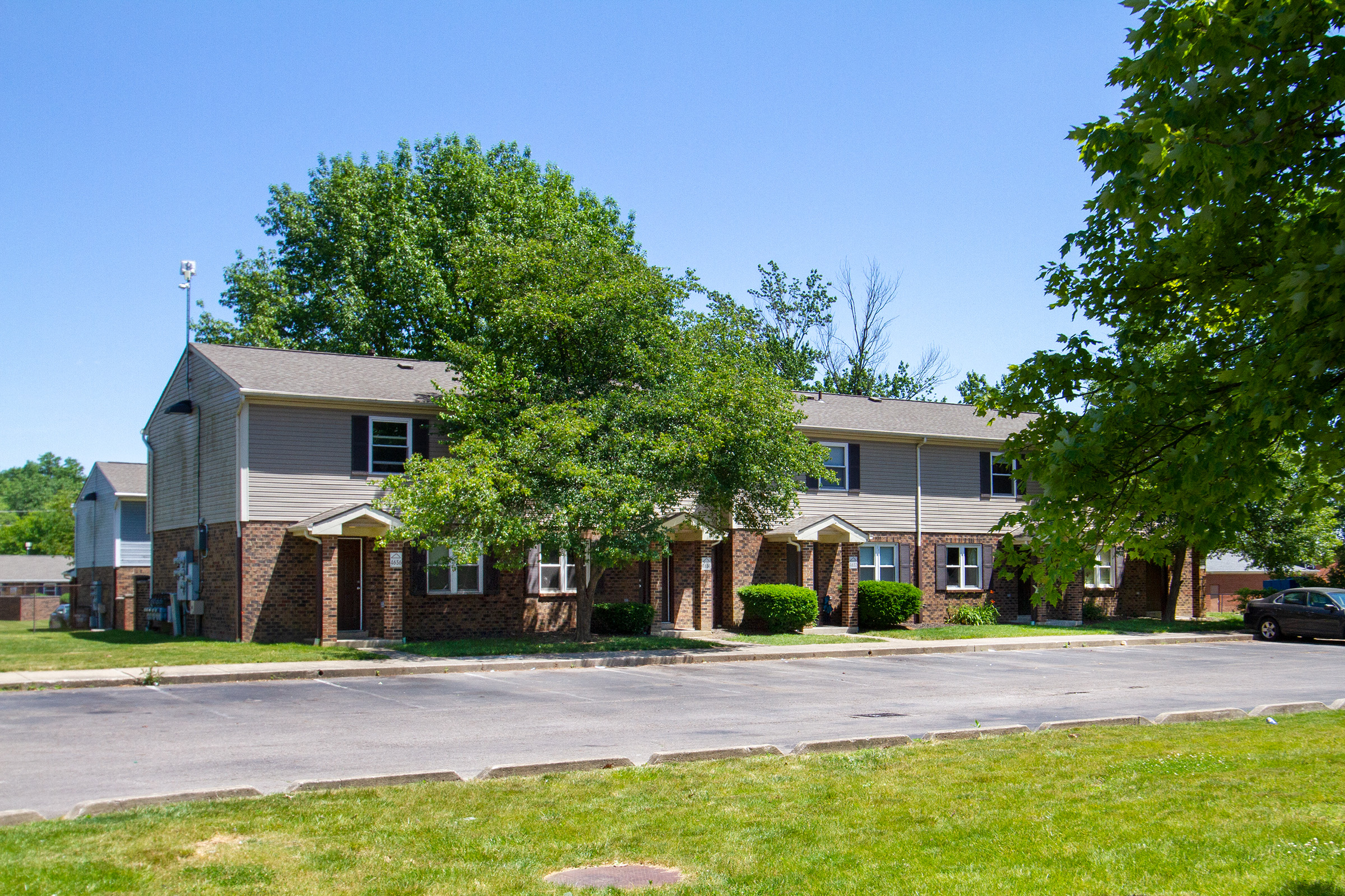 an apartment building with a street in front of it