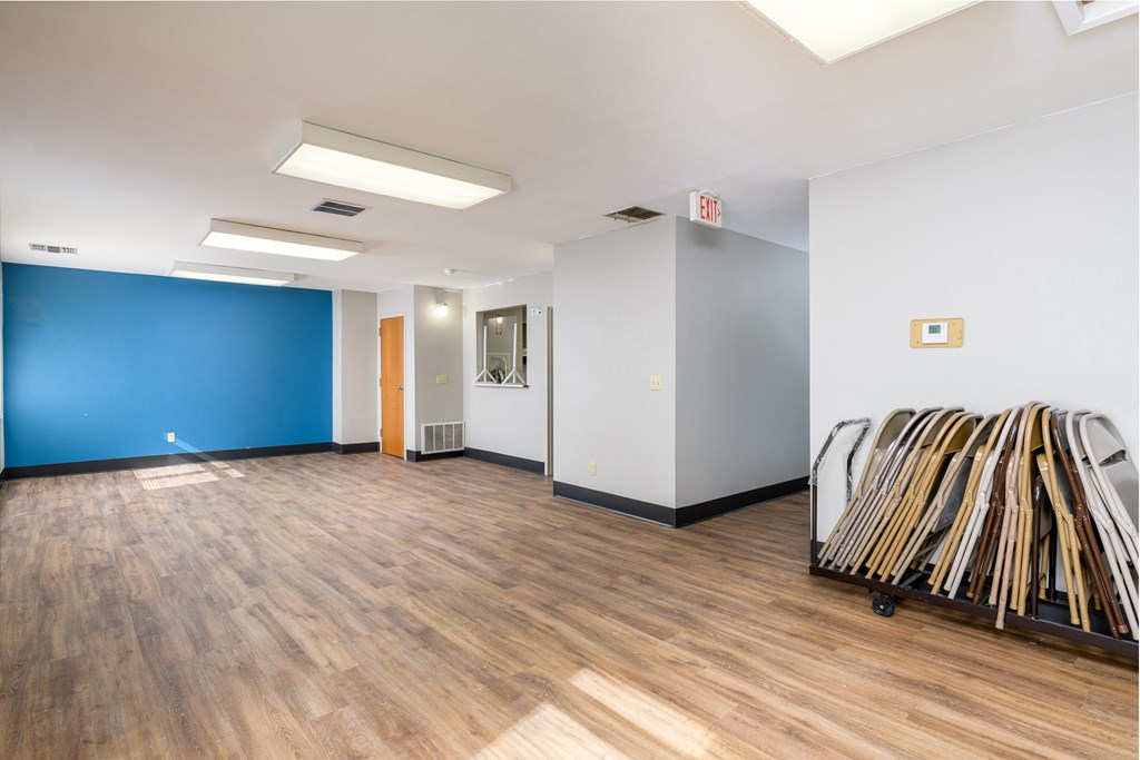 a room with white walls and a blue wall and a pile of racks of wood