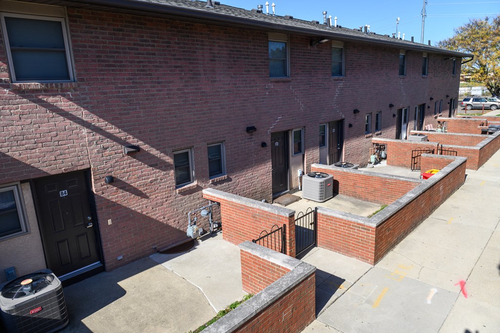 the side of a brick apartment building with balconies
