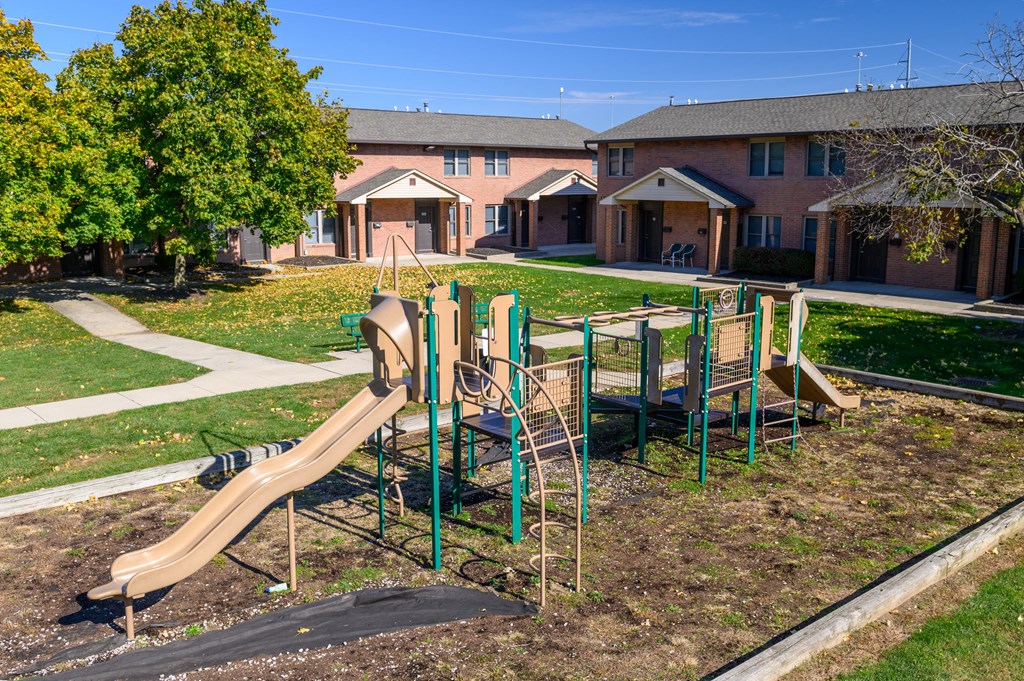 a playground with a slide in a park
