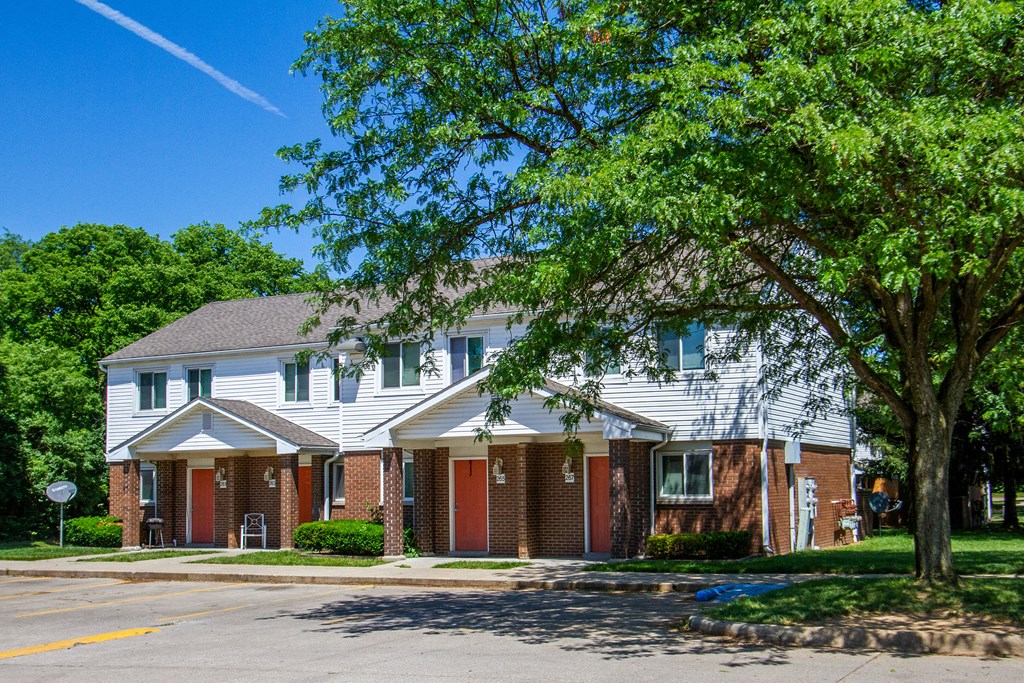 a white house with a tree in front of it
