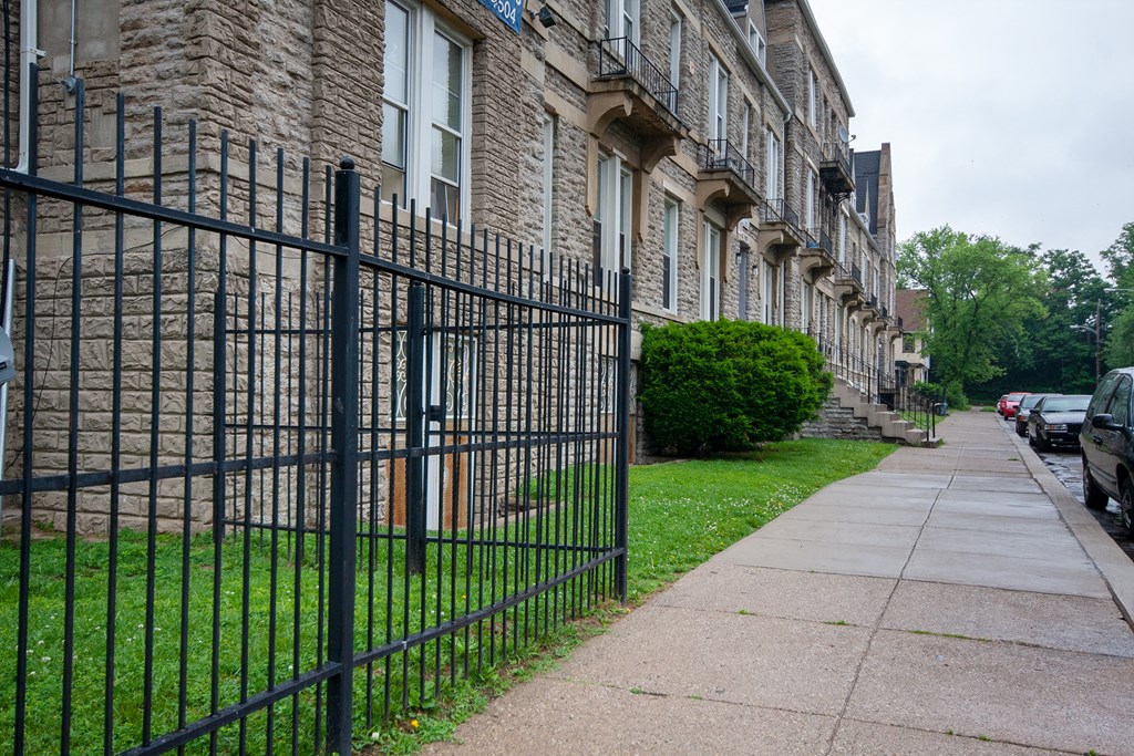a black wrought iron fence in front of a church