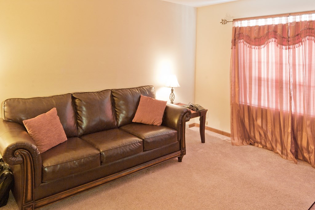 a living room with a couch and a window