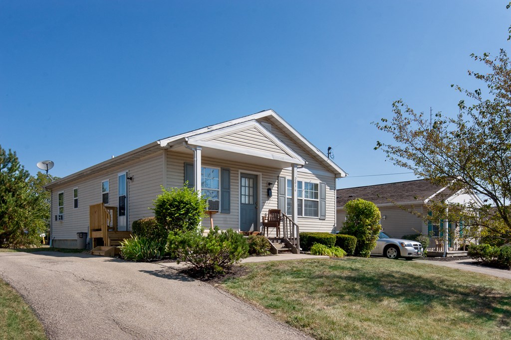 a house with a driveway and a car parked in front of it