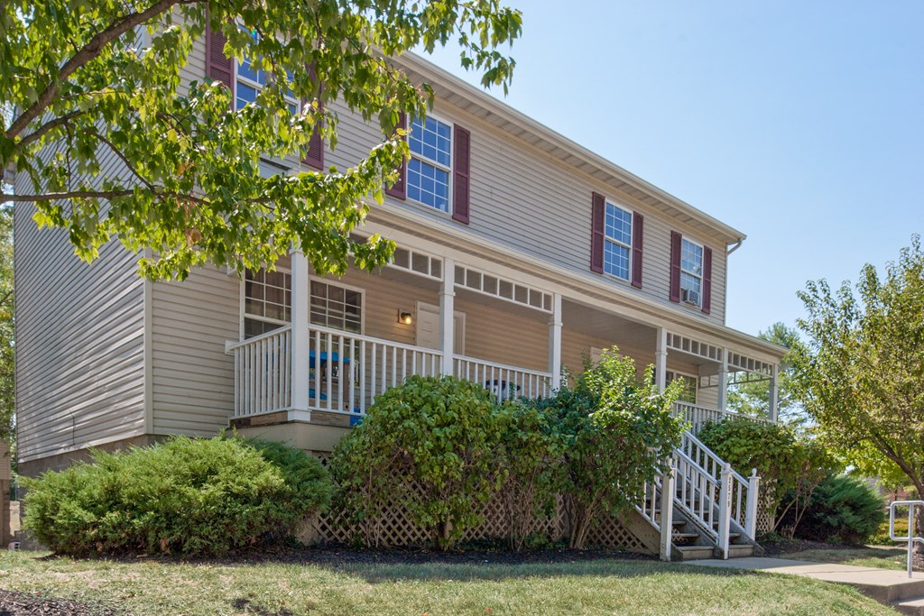 the front of a house with a yard and stairs