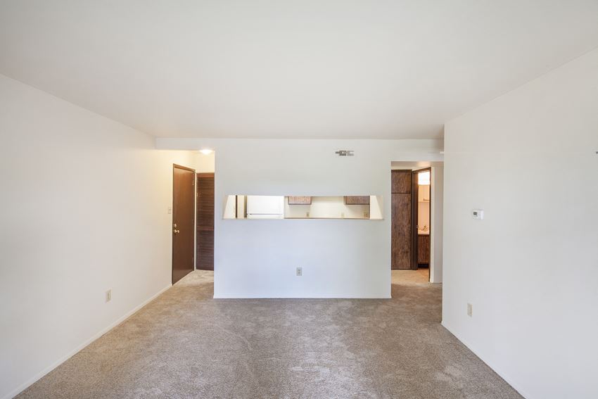 an empty living room with white walls and a white counter top