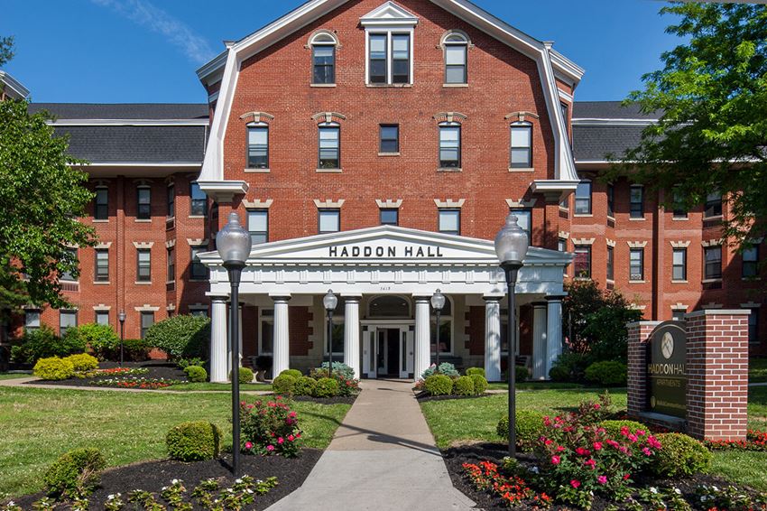 a large brick building with a sidewalk in front of it