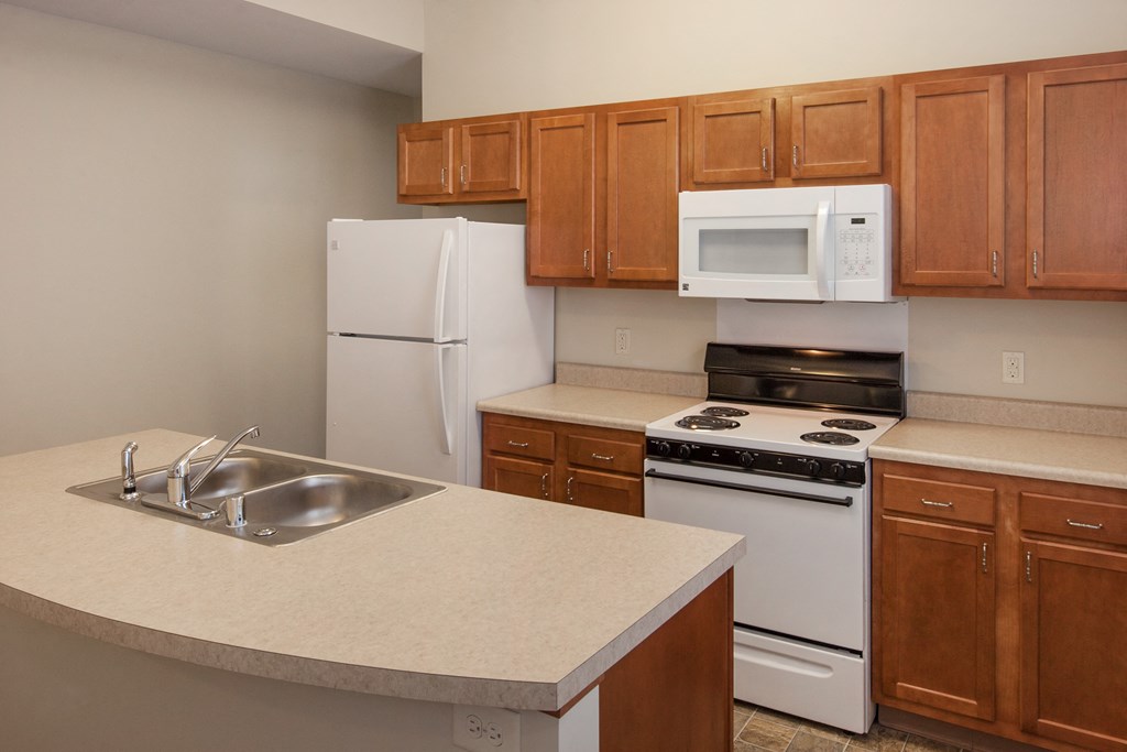 a kitchen with white appliances and wooden cabinets