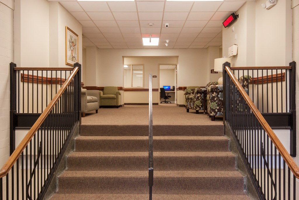 a view of a lobby with stairs and couches