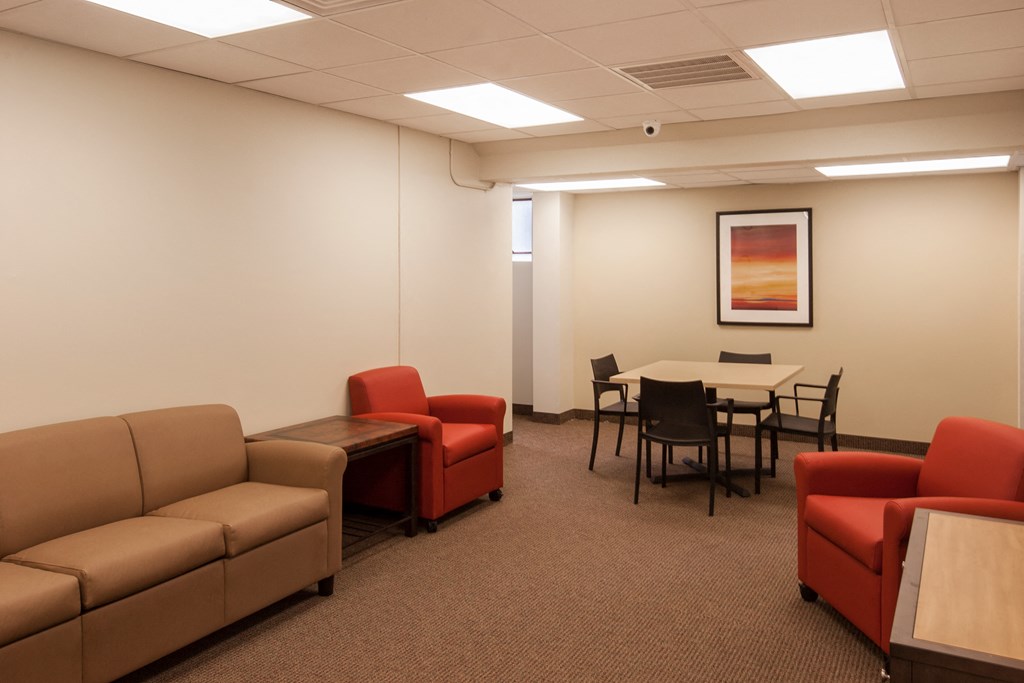 a waiting room with couches and chairs and a table