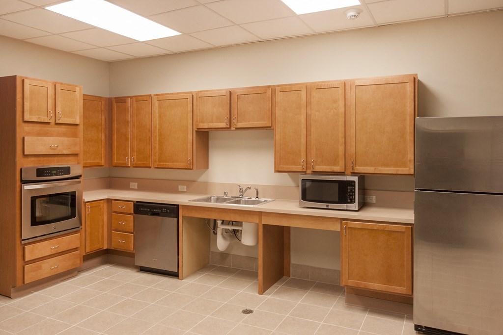 a kitchen with wooden cabinets and stainless steel appliances
