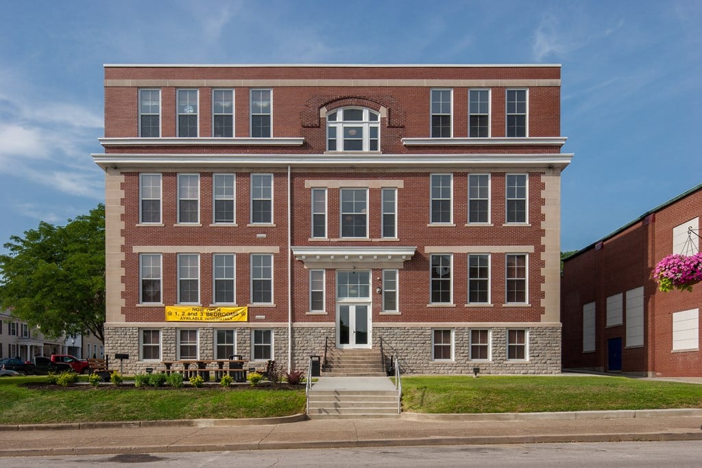 a large brick building on the corner of a street